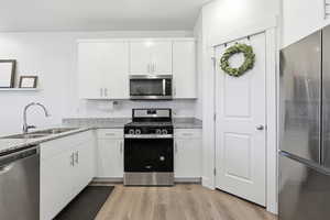 Kitchen featuring stainless steel appliances, white cabinetry, granite countertops and a pantry!
