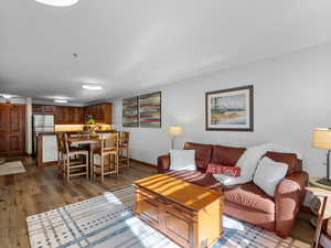 View from balcony door to living area, kitchen table and kitchen.