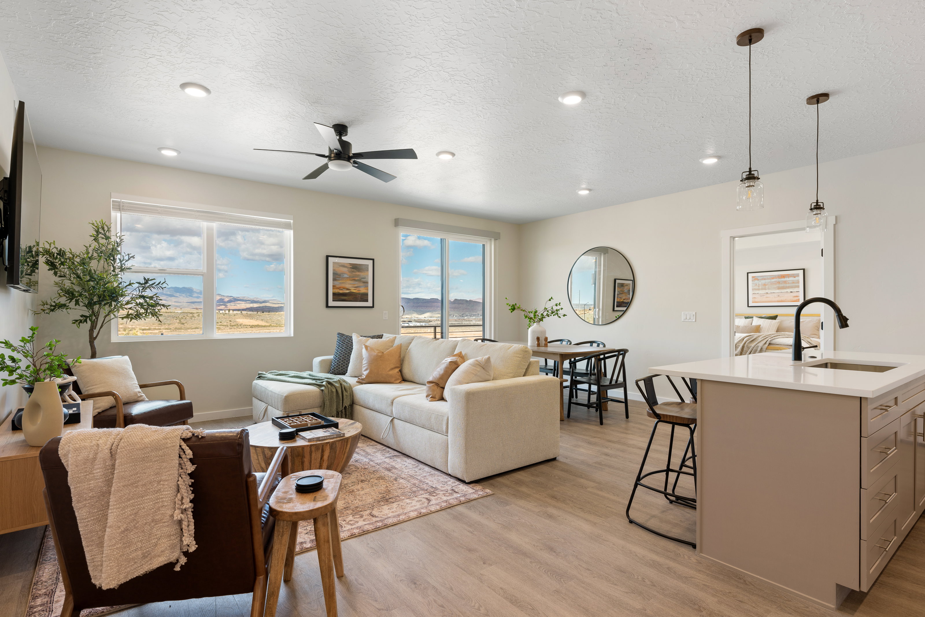 Living room featuring a textured ceiling, light wood-type flooring, plenty of natural light, recessed lighting, and a ceiling fan