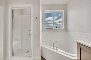 Bathroom with a stall shower and a garden tub