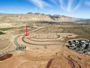 Aerial view of property and surrounding area featuring a mountainous background and a desert landscape