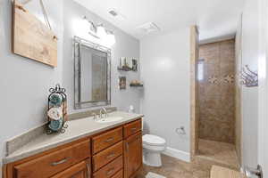 Bathroom featuring walk in shower and vanity