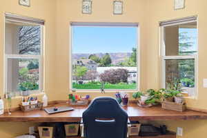 Office space featuring a mountain view and plenty of natural light