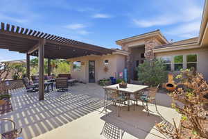 View of patio / terrace featuring an outdoor living / dining area and a pergola