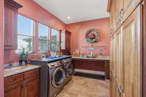 Laundry room featuring cabinet space, independent washer and dryer, and recessed lighting