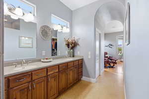 Bathroom featuring double vanity and baseboards