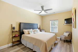 Bedroom with light wood-style flooring and ceiling fan