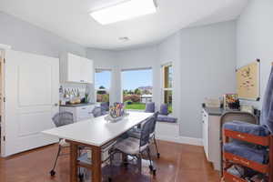 Dining room featuring baseboards and dark tile patterned floors