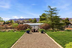 View of green lawn featuring a mountain view
