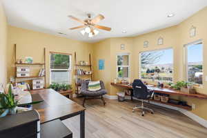 Office featuring a mountain view, light wood-type flooring, ceiling fan, built in study area, and recessed lighting