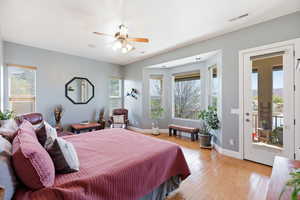 Bedroom with light wood finished floors, a ceiling fan, and access to exterior
