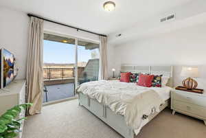 Bedroom with light carpet and access to exterior