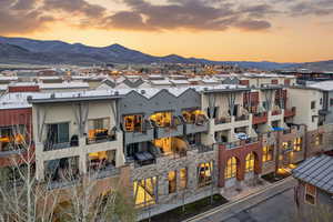 Property at dusk featuring a mountain view