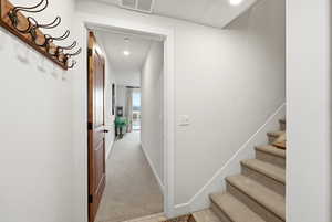 Hall featuring light carpet and recessed lighting