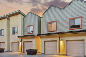 View of front of home with stucco siding and an attached garage