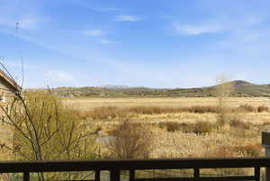View of mountain backdrop featuring rural landscape