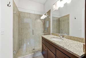 Bathroom featuring vanity and a shower stall
