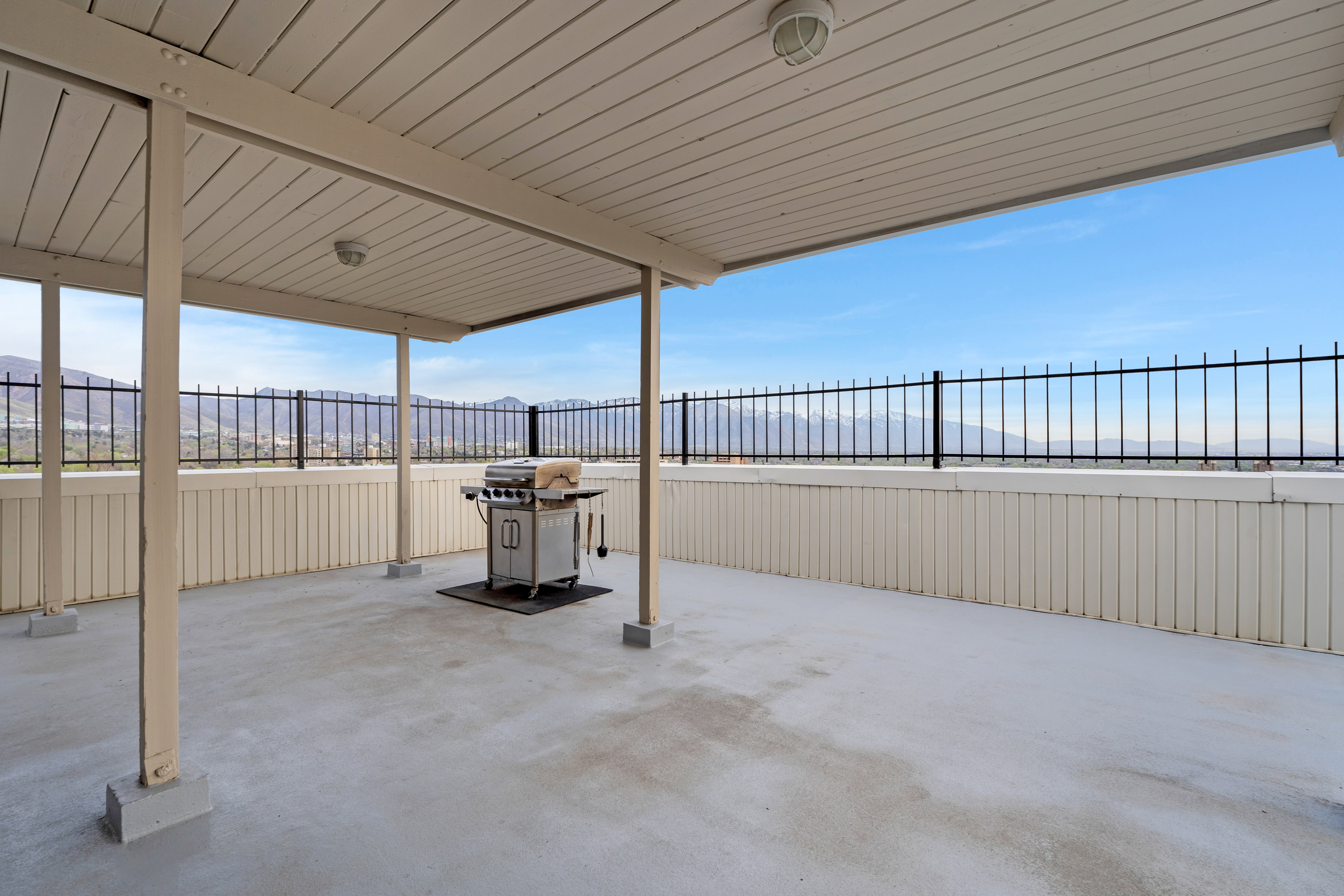 Fenced backyard with a grill