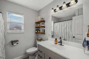 Bathroom featuring vanity and curtained shower