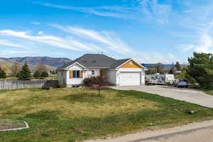 View of front of home featuring a mountain view, concrete driveway, an attached garage, and board and batten siding