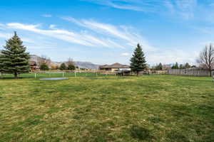 Fenced backyard featuring a mountain view