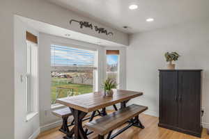 Dining space featuring light wood finished floors and recessed lighting