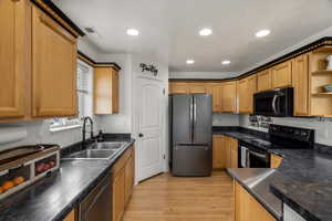 Kitchen featuring stainless steel appliances, open shelves, light wood-style floors, recessed lighting, and wood finish cabinetry