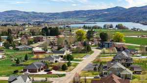 Aerial perspective of suburban area with a water and mountain view