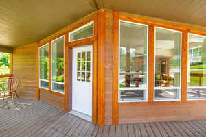 Entrance to property featuring a wooden deck