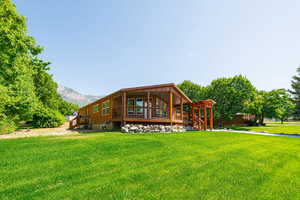 Back of property featuring a yard