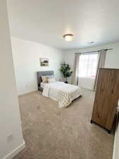 Carpeted bedroom with baseboards