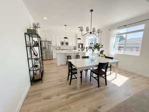 Dining room featuring suspended lighting and light wood finished floors