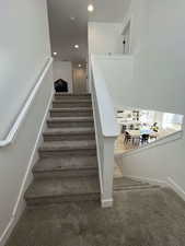 Staircase featuring carpet and recessed lighting