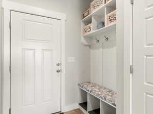 Mudroom with light wood finished floors and baseboards