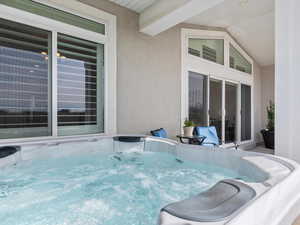 View of patio with a hot tub