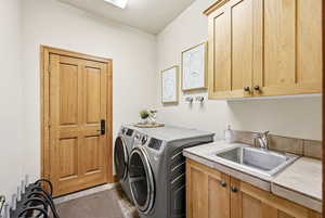 Laundry area with washing machine and clothes dryer and cabinet space