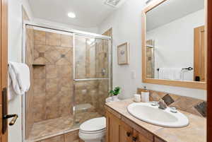 Bathroom with vanity and a stall shower