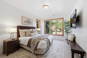 Bedroom with light carpet and baseboards