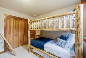Bedroom featuring a closet and light carpet