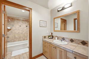 Full bathroom with vanity and shower / washtub combination
