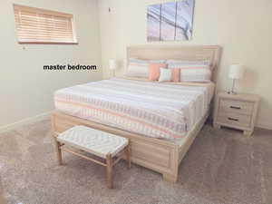 Master bedroom featuring carpet floors and with an ensuite bathroom.