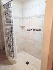 Master ensuite bathroom featuring a shower stall and tile patterned floors