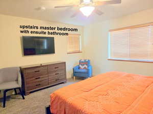 2nd Master bedroom featuring light carpet and a ceiling fan and ensuite bathroom.