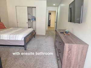 Bunk bedroom with light carpet, recessed lighting, and a closet & ensuite bathroom.