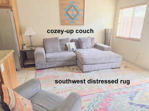 Living area featuring light tile patterned floors opens to patio, with hot tub.