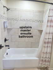 2nd master ensuite full bathroom with shower / bathtub combination with curtain