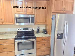 Kitchen with stainless steel appliances and granite counters