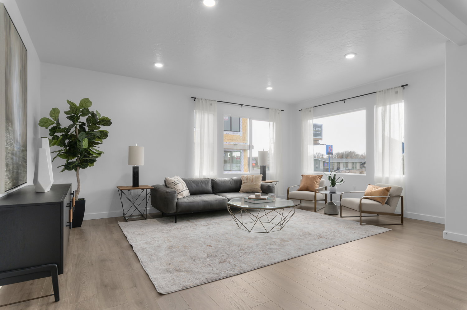 Living room with light wood-style floors and recessed lighting
