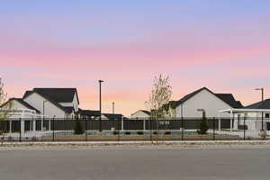 View of front facade featuring a community pool and a residential view