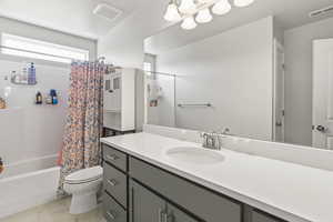 Bathroom featuring vanity and shower / tub combo with curtain